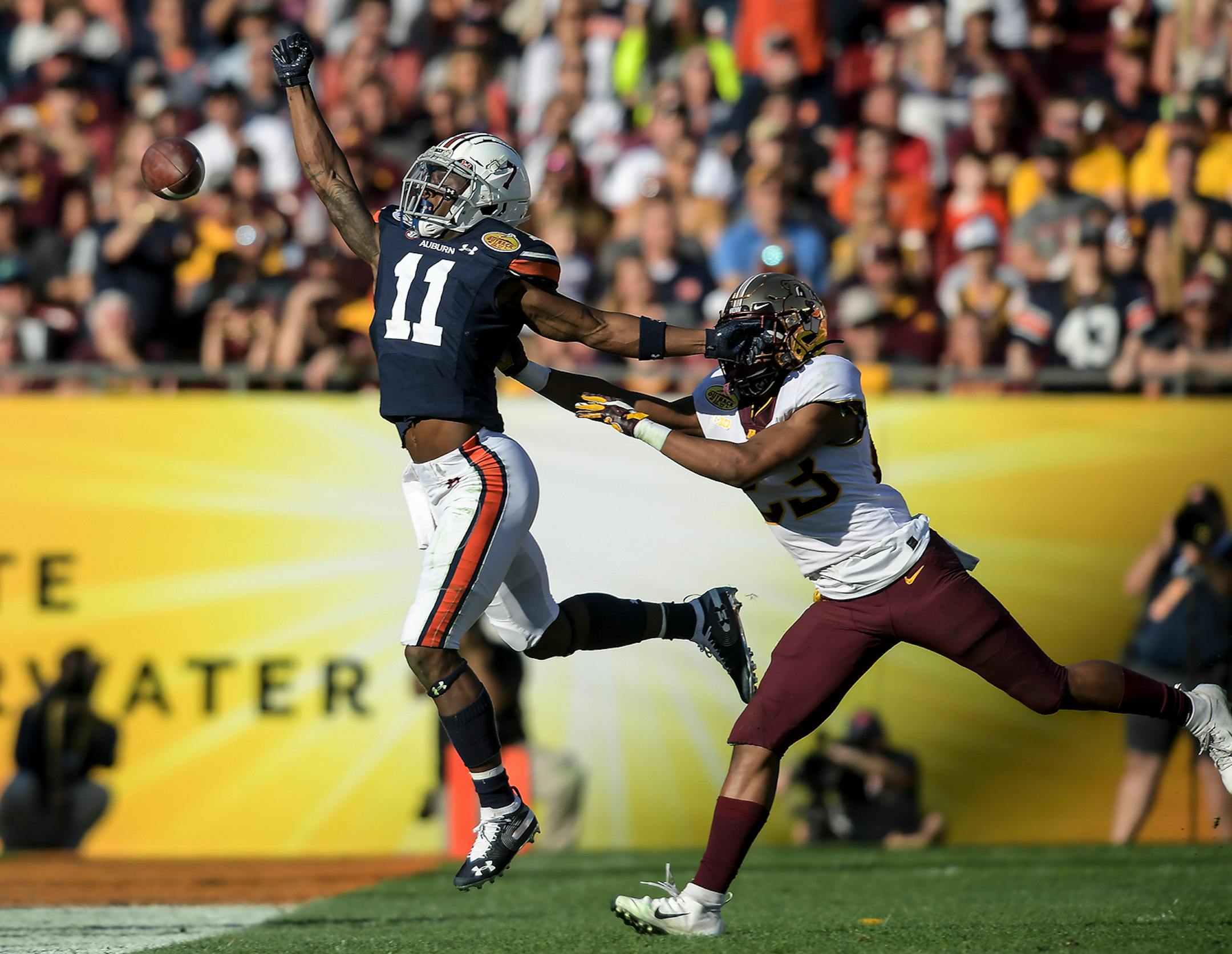 Auburn Tigers wide receiver Shedrick Jackson (11) was unable to come up with a reception as he was defended by Minnesota Gophers defensive back Jordan Howden (23) in the third quarter.
