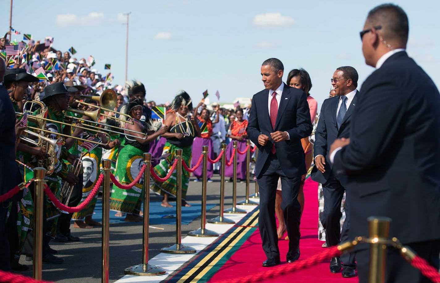 President Barack Obama dances as he is welcomed by President Jakaya Kikwete of Tanzania during his official arrival ceremony at Julius Nyerere International Airport in Dar es Salaam, Tanzania, July 1, 2013. Thousands of Tanzanians greeted Obama as he began the last leg of a three-nation tour of Africa, having visited Senegal and South Africa last week. (Doug Mills/The New York Times) ORG XMIT: MIN2013070119475667