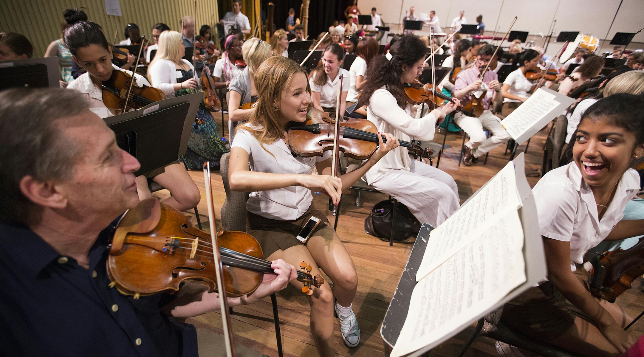 Violin players Christa Morera, from right, and Danielle Gonzalez of the Orquesta Sinfonica Juvenil del Conservatorio takes part in a side-by-side rehearsal with Roger Frisch of the Minnesota Orchestra at Teatro Nacional in Havana, Cuba on Friday, May 15, 2015. ] LEILA NAVIDI leila.navidi@startribune.com / ORG XMIT: MIN1505151555191128