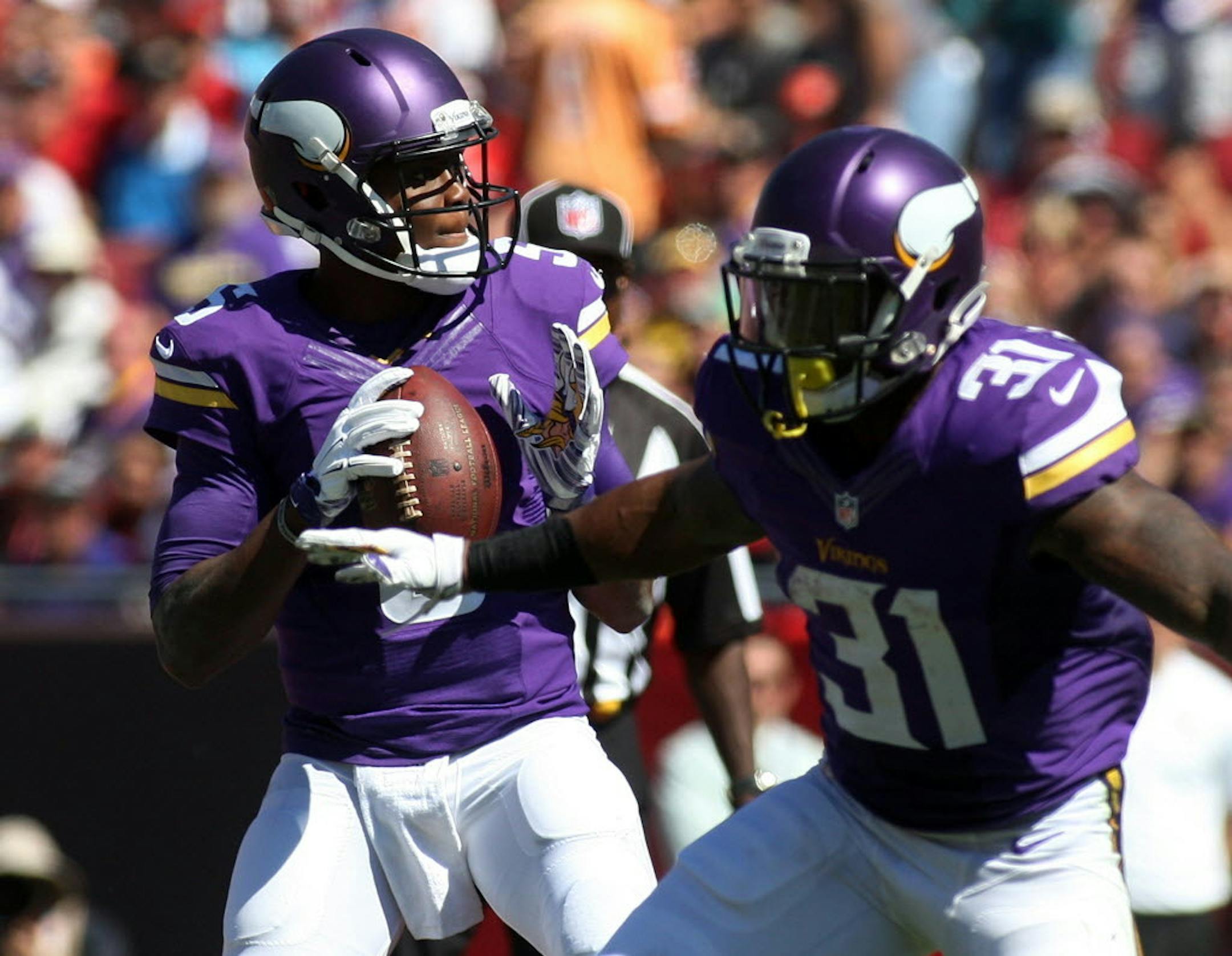 Minnesota Vikings quarterback Teddy Bridgewater (5) looks to pass as running back Jerick McKinnon (31) blocks during the first quarter of an NFL football game against the Tampa Bay Buccaneers Sunday.