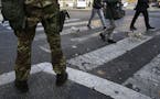 An Italian soldier patrols in downtown Rome, Thursday, Nov. 19, 2015. The State Department is warning that St. Peter's Basilica in Rome, Milan's cathe