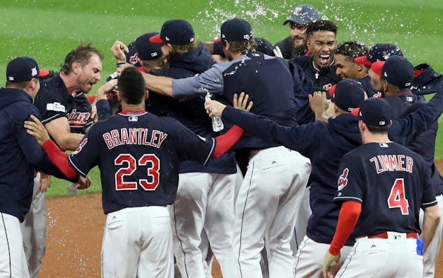 The Cleveland Indians mob teammate Yan Gomes, who drove in the winning run in the 13th inning against the New York Yankees during Game 2 of the Americ