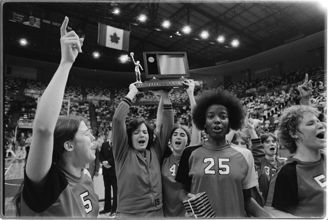St. Paul Central's Linda Roberts (#25) celebrated with teammates after beating Benilde-St. Margaret's 49-47 to win the Minnesota State High School Class AA Basketball Tournament in 1976. Teammates with Roberts include Bonnie Lubben (#5), Susan Smith (in jacket, holding trophy) Teresa Tierney (#41), Kim Weber(#33) and Debbie Krengel (#55, far right).