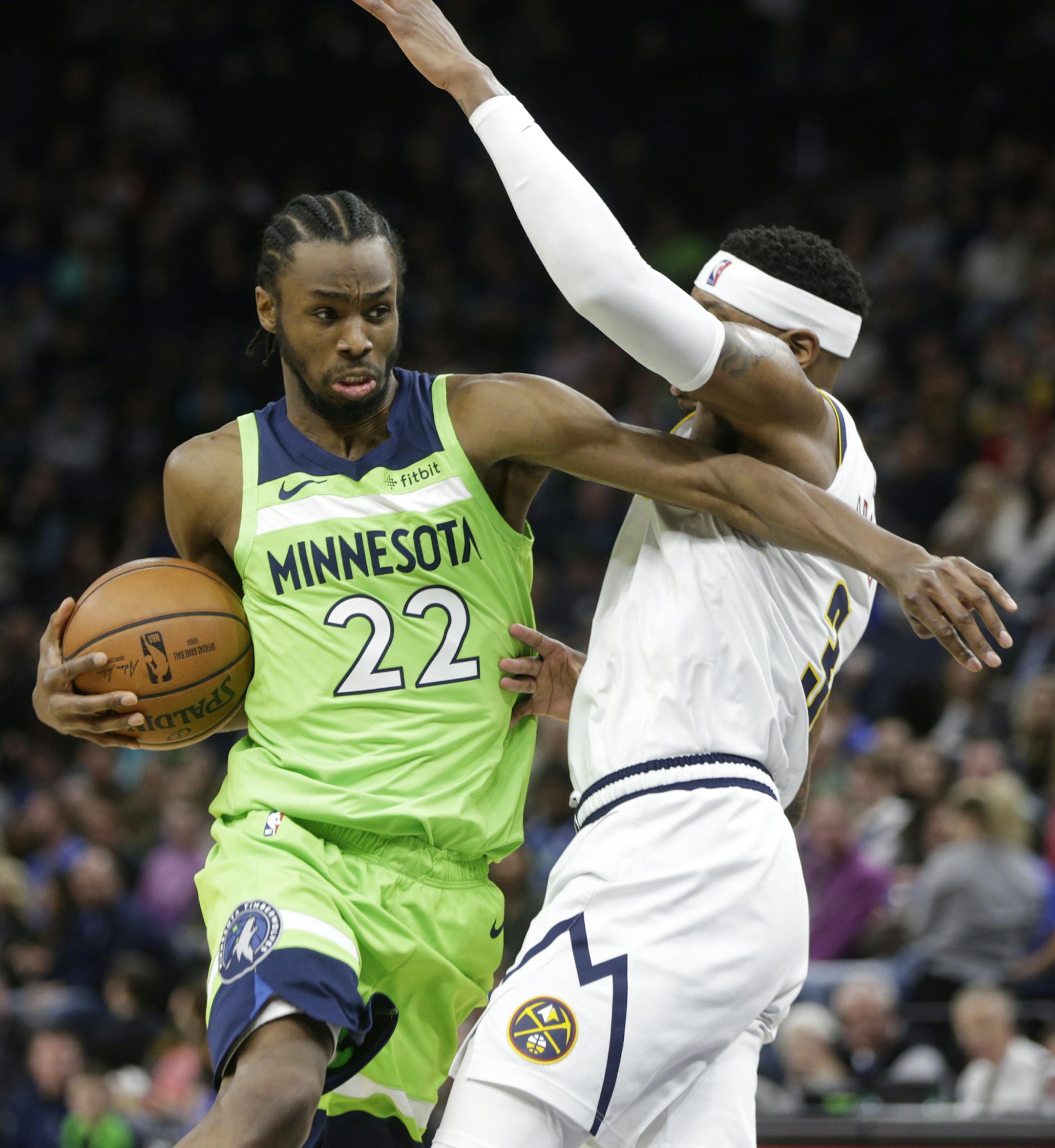 Minnesota Timberwolves forward Andrew Wiggins (22) drives around Denver Nuggets forward Torrey Craig (3) during the first half of an NBA basketball game Saturday, Feb. 2, 2019, in Minneapolis. (AP Photo/Paul Battaglia)