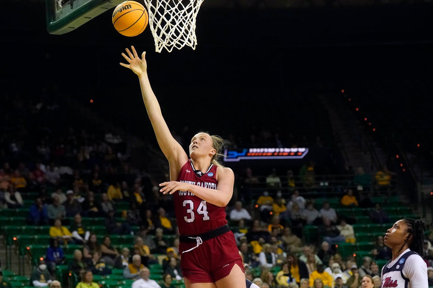 South Dakota center Hannah Sjerven (34) goes in for a lay-up during the second half of a college basketball game against Mississippi in the first round of the NCAA tournament in Waco, Texas, Friday, March 18, 2022. South Dakota won 75-61. (AP Photo/LM Otero)