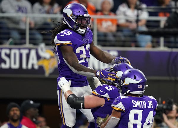 Vikings running back Dalvin Cook was lifted up by offensive tackle Brian O'Neill after he scored a touchdown in the fourth quarter against Denver.