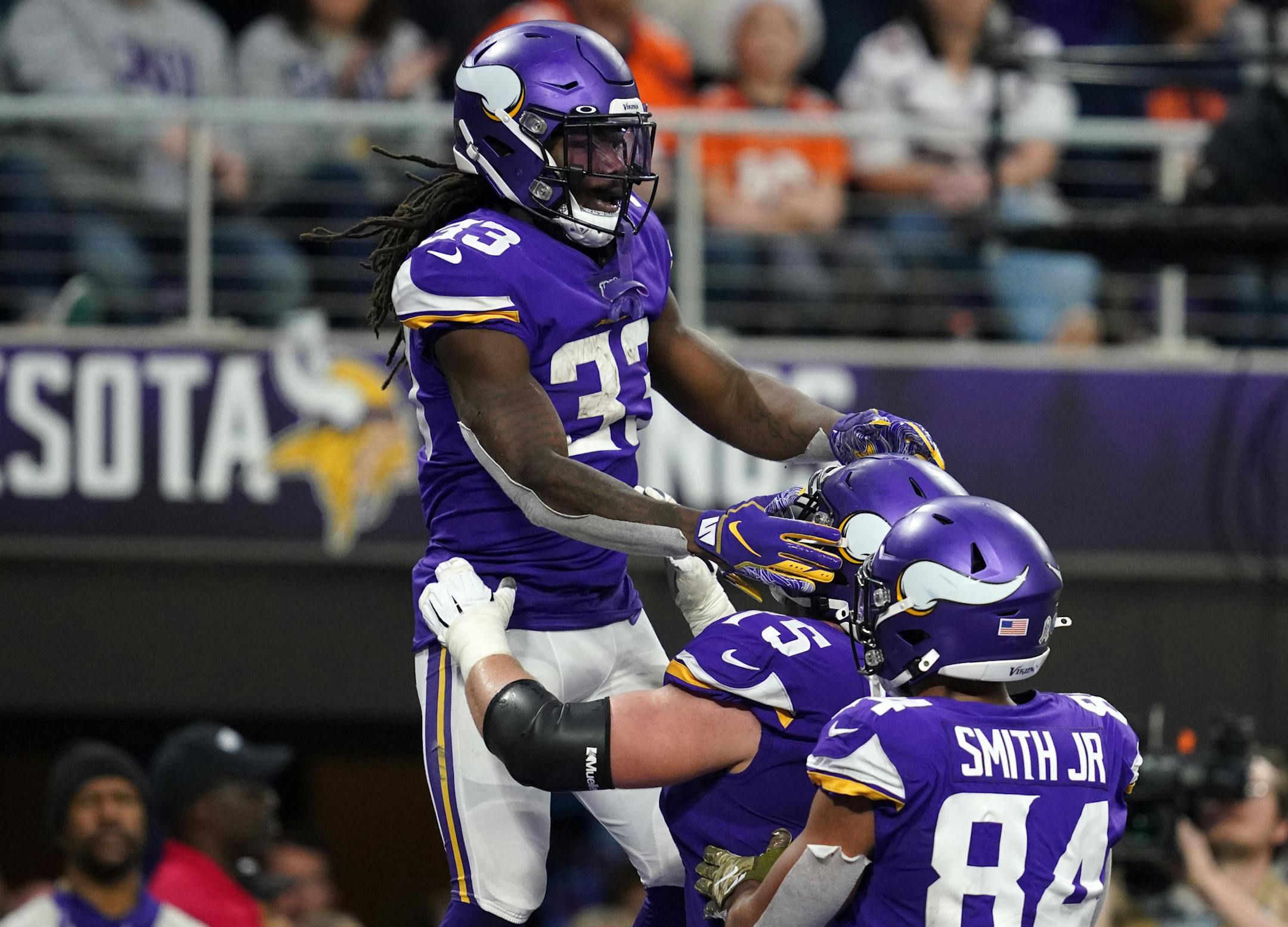 Vikings running back Dalvin Cook was lifted up by offensive tackle Brian O'Neill after he scored a touchdown in the fourth quarter against Denver.