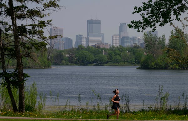 A runner jogs around Lake of the Isles in Minneapolis on Monday. The Minnesota Pollution Control Agency extended an air quality red alert — consider