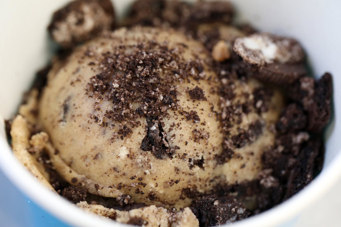 A scoop of cookie borer (cookies and cream) cookie dough sat ready for a patron on the Dough Dough food truck Wednesday in downtown Minneapolis. ] ANTHONY SOUFFLE &#xef; anthony.souffle@startribune.com Dough Dough food truck has become a craze, drawing long lines as it sat parked Wednesday, May 24, 2017 in downtown Minneapolis.