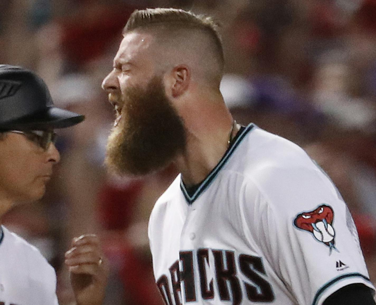 Arizona Diamondbacks' Archie Bradley (25) celebrate his two run triple against the Colorado Rockies during the seventh inning of the National League wild-card playoff baseball game, Wednesday, Oct. 4, 2017, in Phoenix. (AP Photo/Matt York)