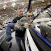Tory Maxa of Shakopee held up his son Kaeden, 7, to get a better look inside a boat at the Minneapolis Boat Show at the Minneapolis Convention Center 