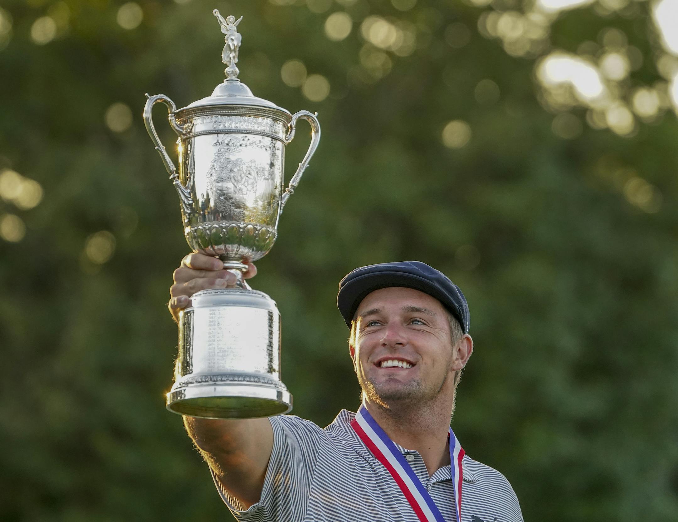 Bryson DeChambeau, of the United States, holds up the winner's trophy after winning US Open Golf Championship, Sunday, Sept. 20, 2020, in Mamaroneck, N.Y. (AP Photo/John Minchillo)