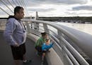 Kevin and Jenny McLaren of Hudson, Wis. check out the view of the St. Croix River from closer to the Wisconsin side of the bridge with their son Tate,