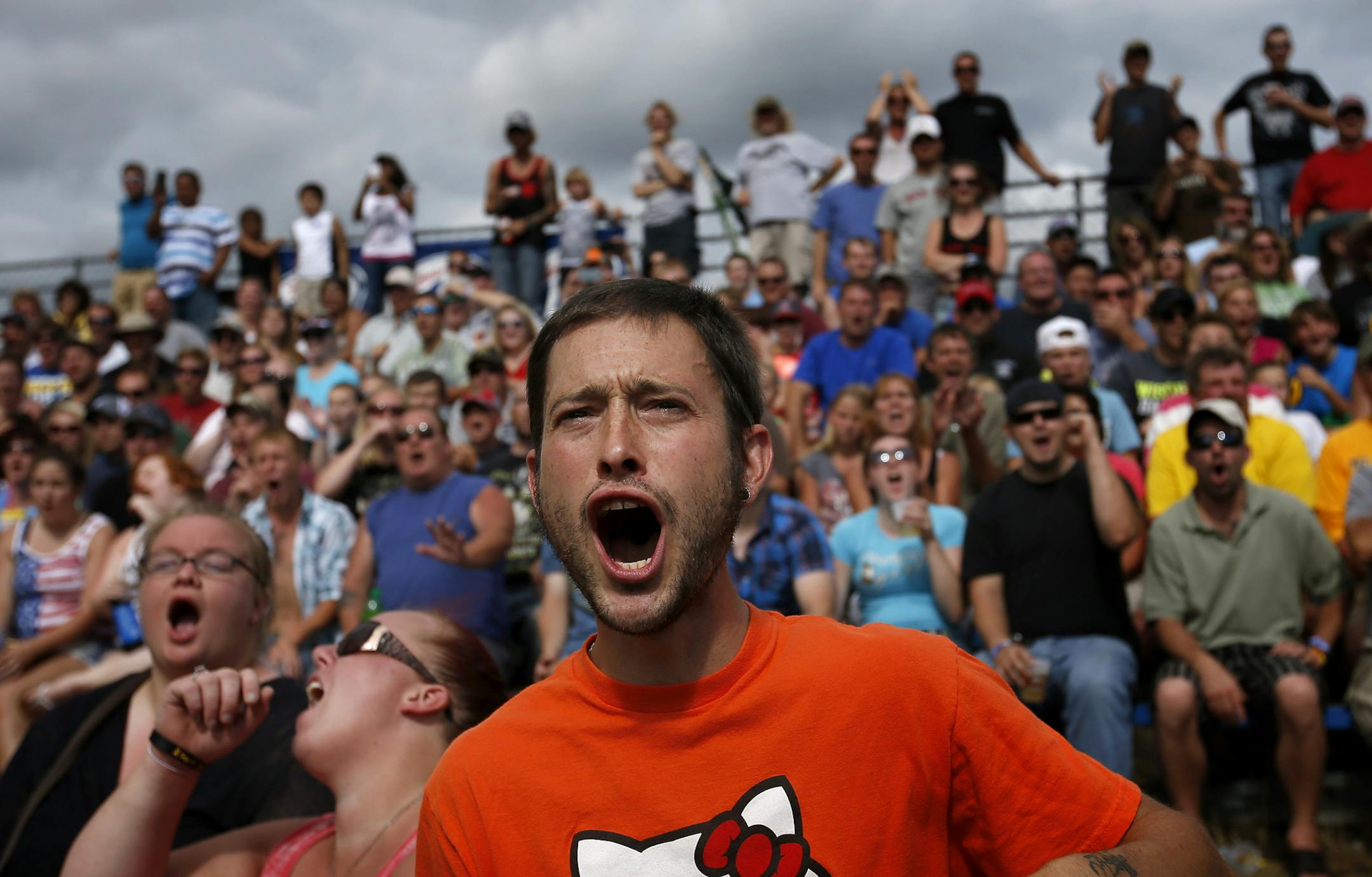 Jake Carter, 32, of Brooklyn Center and other spectators reacted during the Demolition Derby at the Anoka County Fair on Sunday afternoon.