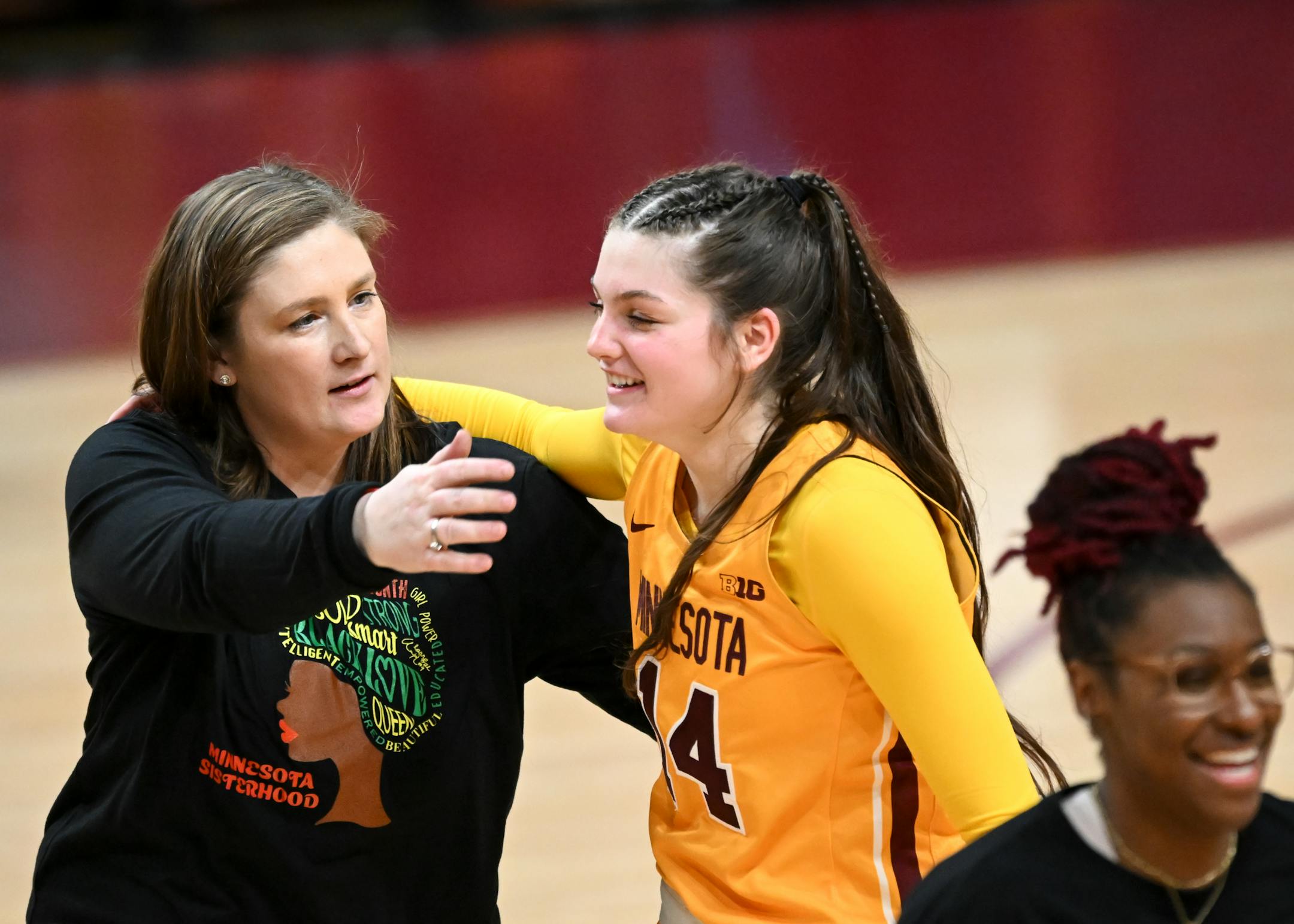Minnesota head coach Lindsay Whalen embraces guard Isabelle Gradwell (14) after their team's win off a last-second 3-pointer by Gradwell against Nebraska.