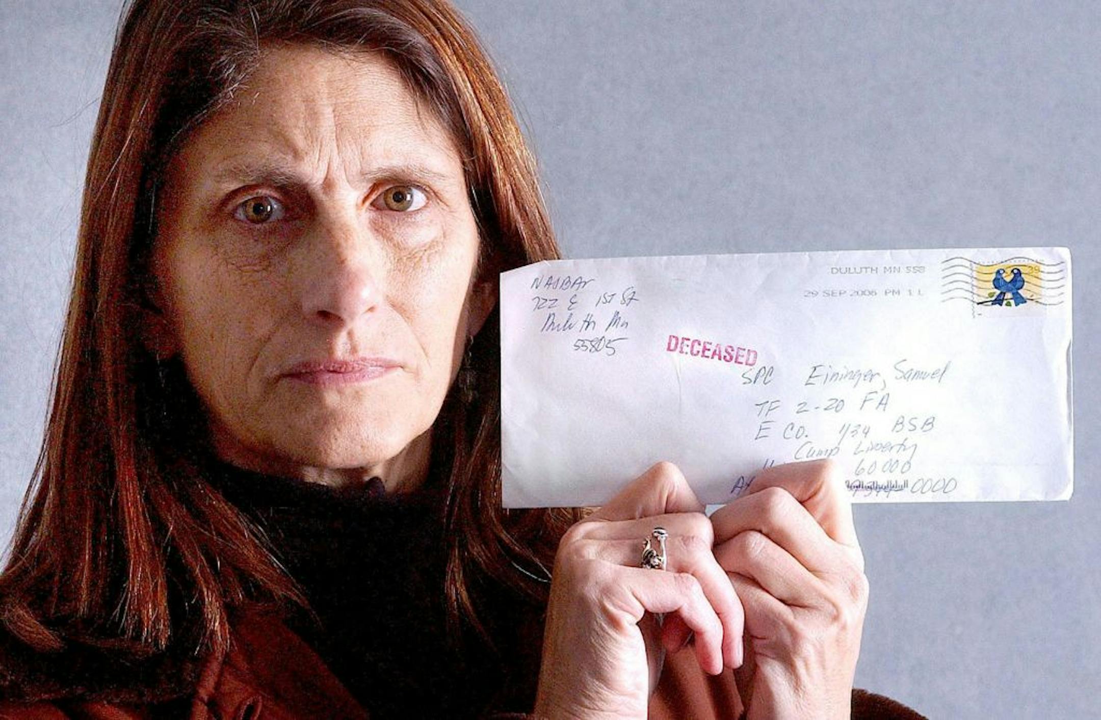 Joan Najbar of Duluth held the letter returned to her with "deceased" stamp.