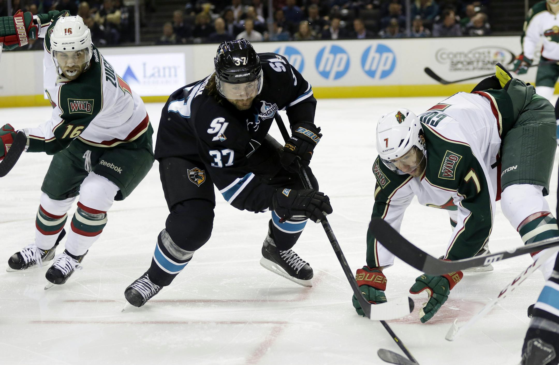 The Wild’s Jason Zucker, left, San Jose’s Adam Burish and Matt Cullen battled for the puck. Cullen’s return — one of the questions below — for next season is uncertain.