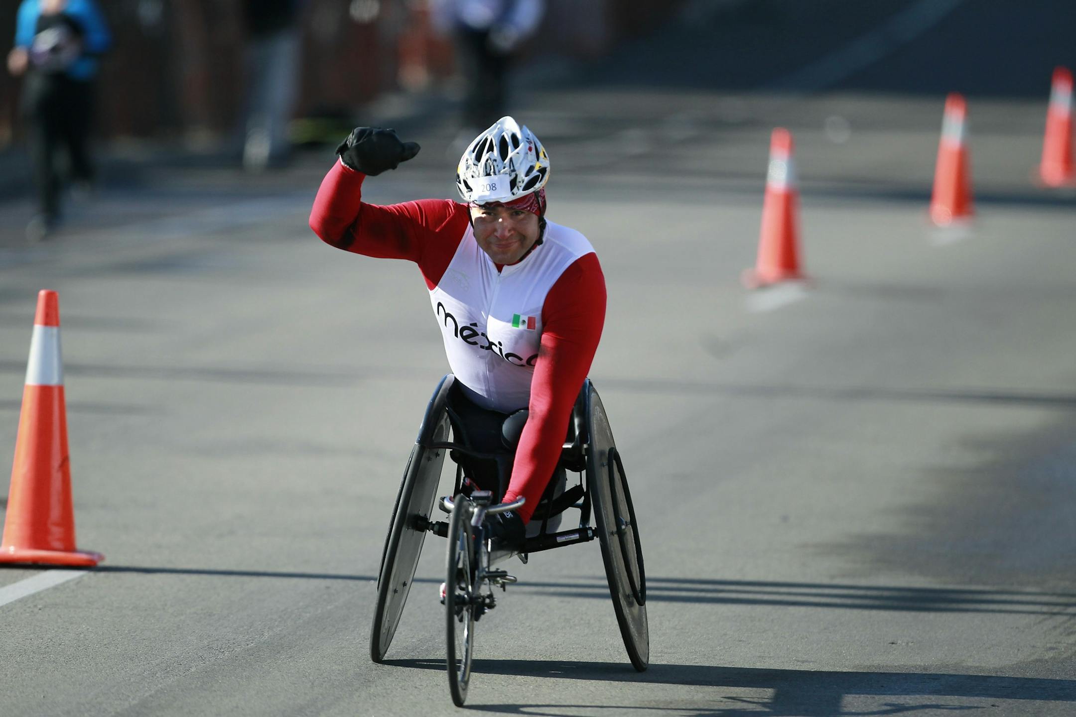 Saul Mendoza crossed the finish line to a warm reception after his fourth consecutive wheelchair title.