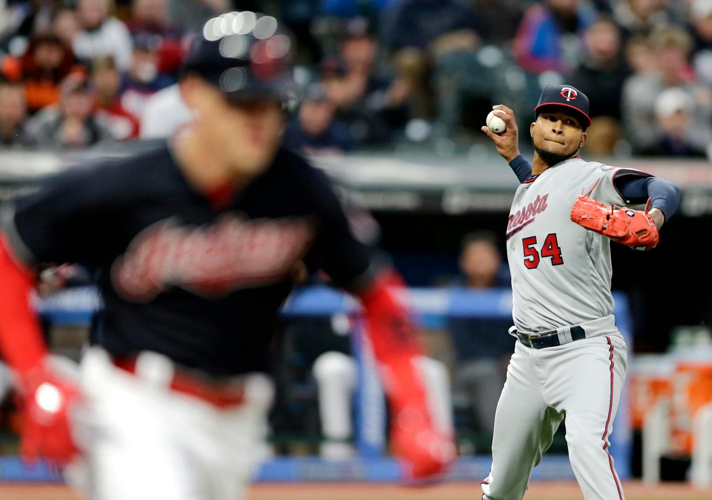 Minnesota Twins starting pitcher Ervin Santana, right, throws out Cleveland Indians' Brandon Guyer, left, at first base after Guyer bunted in the fifth inning of a baseball game, Friday, May 12, 2017, in Cleveland. (AP Photo/Tony Dejak)