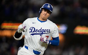 The Dodgers' Shohei Ohtani celebrates as he runs the bases after hitting a home run during the seventh inning against the Giants on Wednesday night.