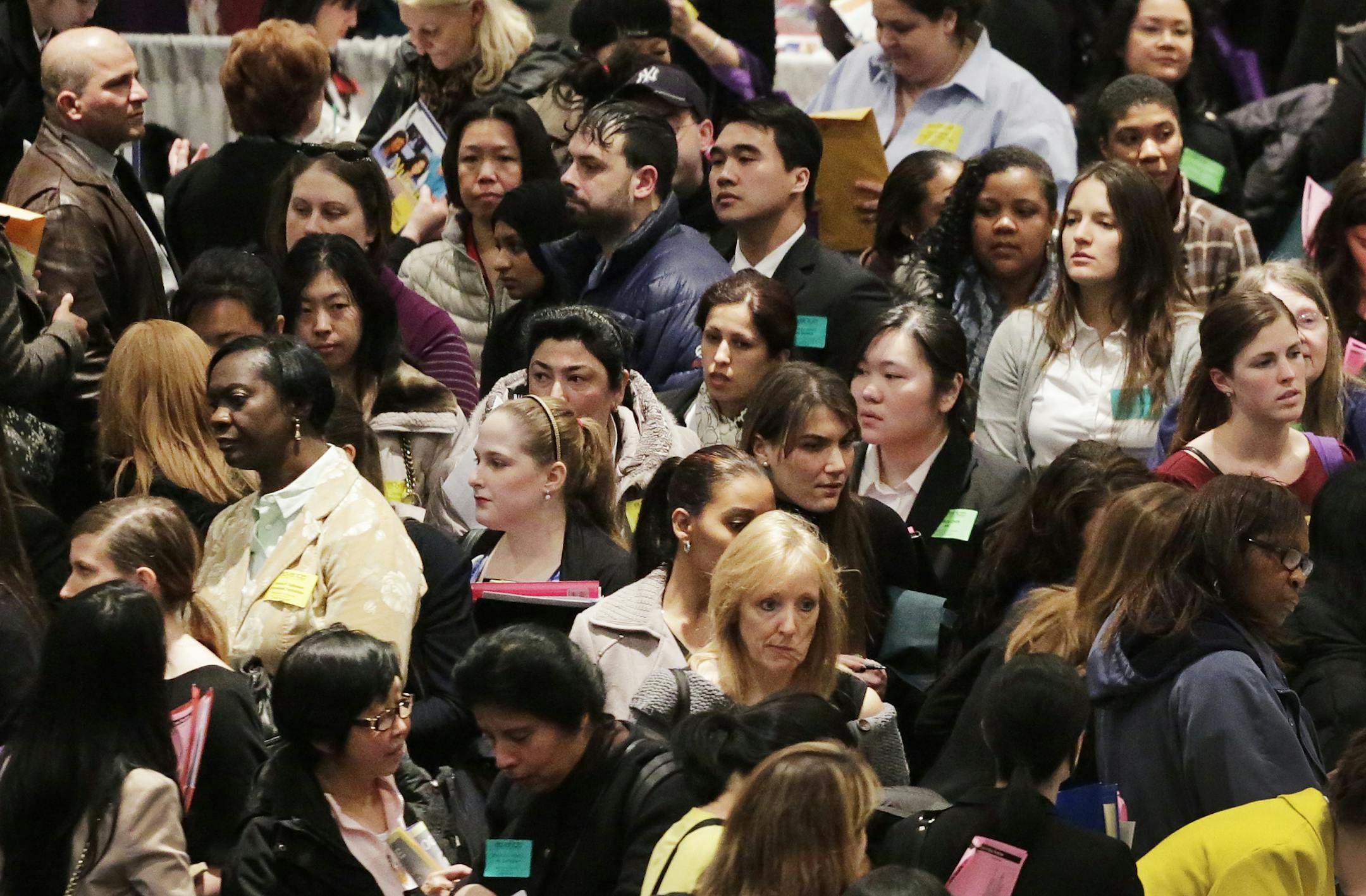 A crowd of job seekers attends a health care job fair, Thursday, March 14, 2013 in New York. Fewer Americans sought unemployment aid last week, reducing the average number of weekly applications last month to a five-year low. The drop shows that fewer layoffs are strengthening the job market. The Labor Department said Thursday that applications fell 10,000 to a seasonally adjusted 332,000. That cut the four-week average to 346,750, the lowest since the week of March 8, 2008, just several months