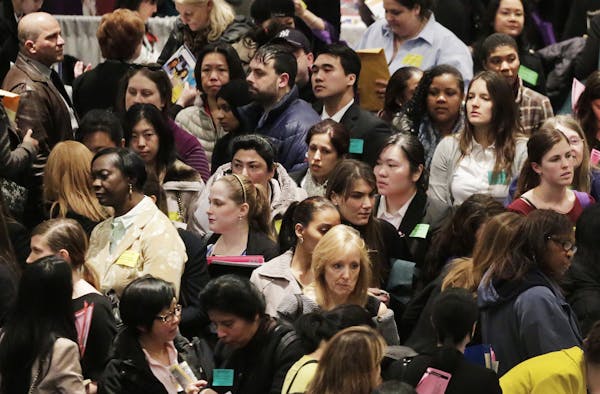 A crowd of job seekers attends a health care job fair, Thursday, March 14, 2013 in New York. Fewer Americans sought unemployment aid last week, reduci