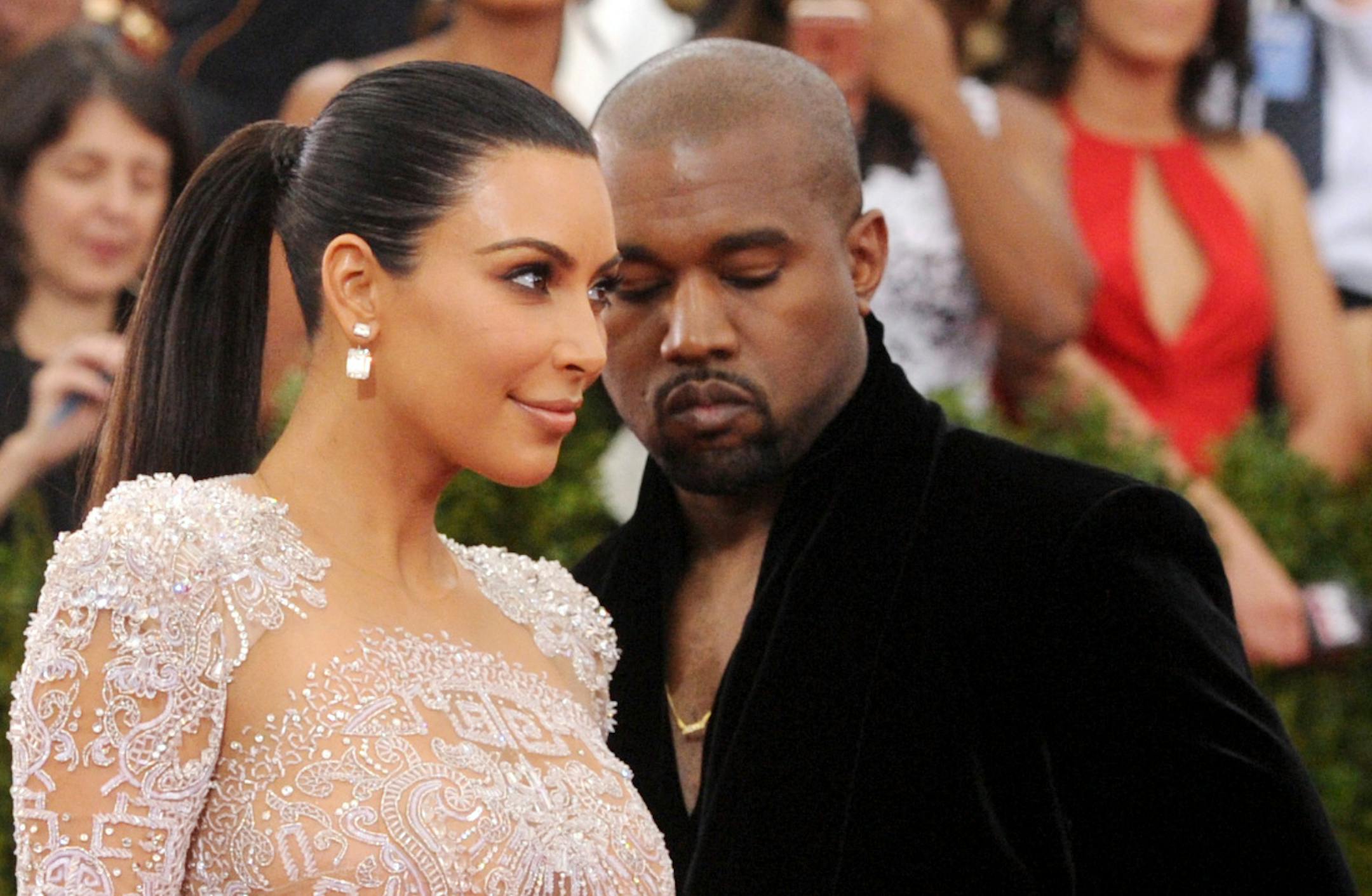 FILE - In this May 4, 2015, file photo, Kim Kardashian, left, and Kanye West arrive at The Metropolitan Museum of Art's Costume Institute benefit gala in New York. Kardashian posted a tribute to West on Instagram to mark the couple's second wedding anniversary on May 24, 2016. (Photo by Charles Sykes/Invision/AP, File)
