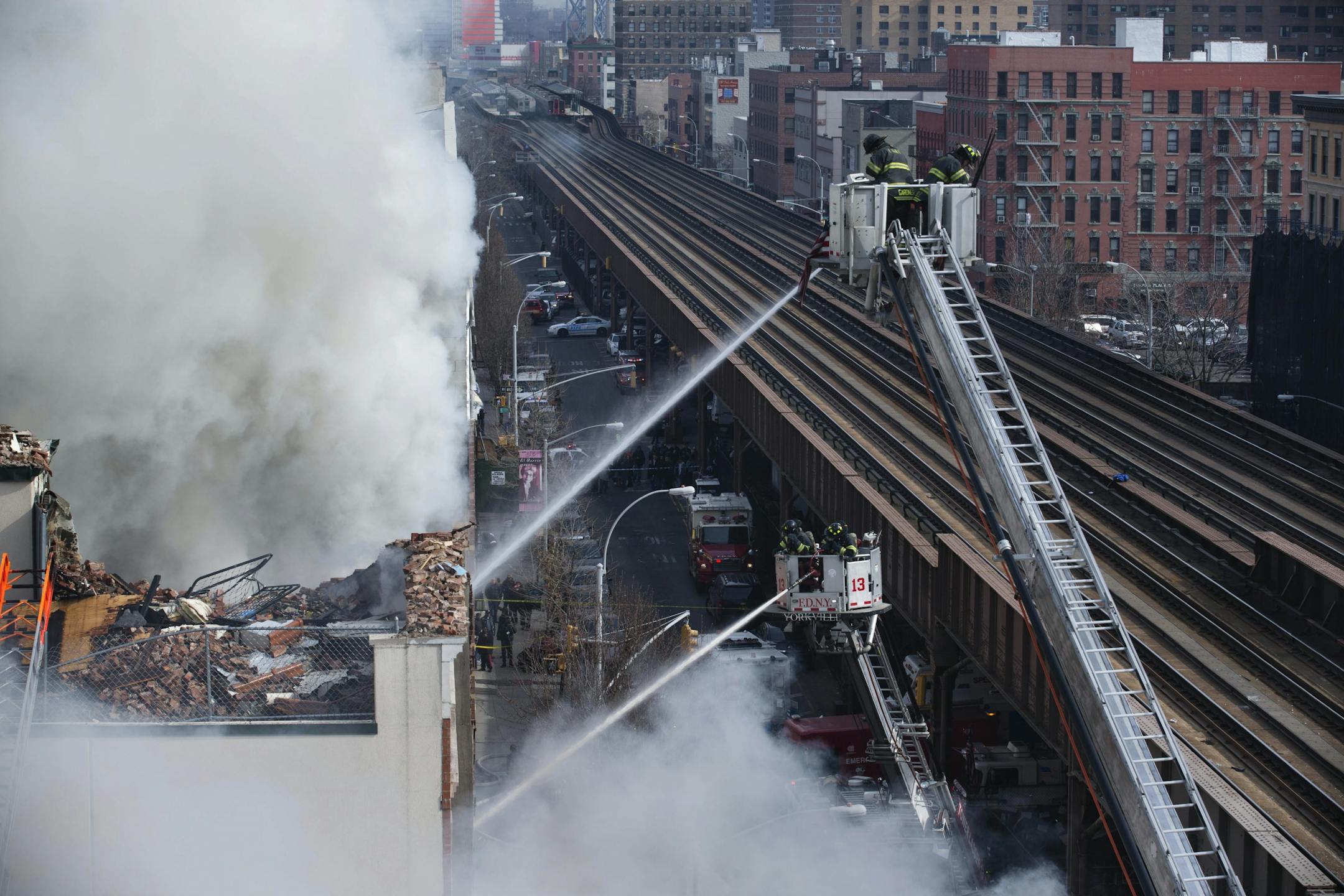 Firefighters respond to a fire on 116th Street in Harlem after a building exploded in huge flamesleading to the collapse of at least one building and several injuries, Wednesday, March 12, 2014, in New York.
