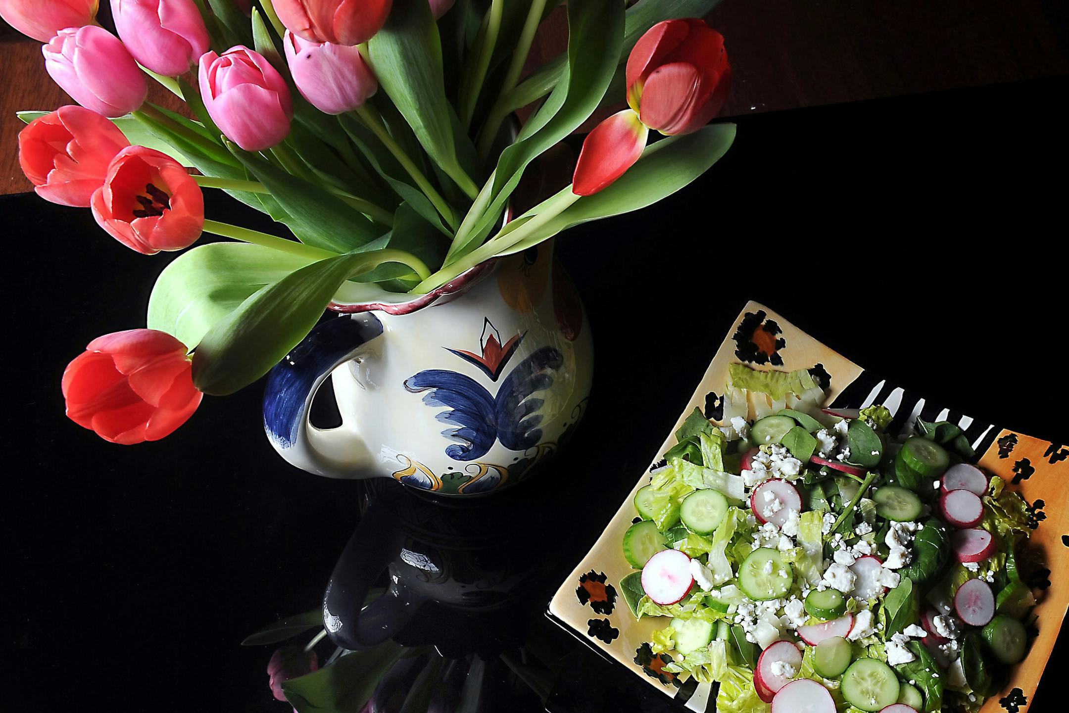 Tulips adorn a table with a spring salad with spinach, romaine lettuce, radish and cucumber, served with a creamy mint dressing. (Nate Guidry/Pittsburgh Post-Gazette/TNS)