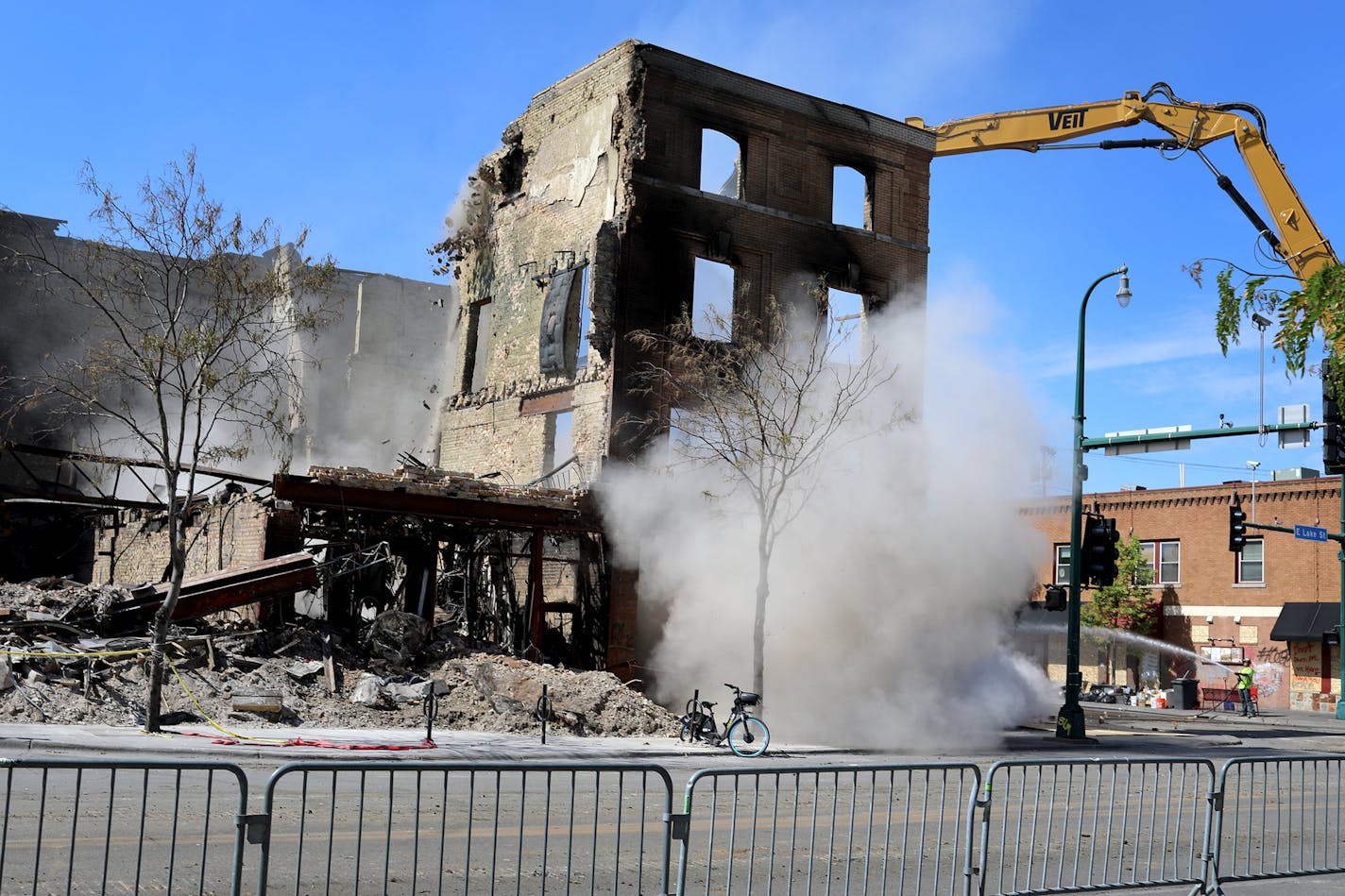 Heavy equipment knocked down a portion of a wall from the iconic old brick building that housed El Nuevo Rodeo near Lake St. and S. 27th Ave on Tuesday in Minneapolis.