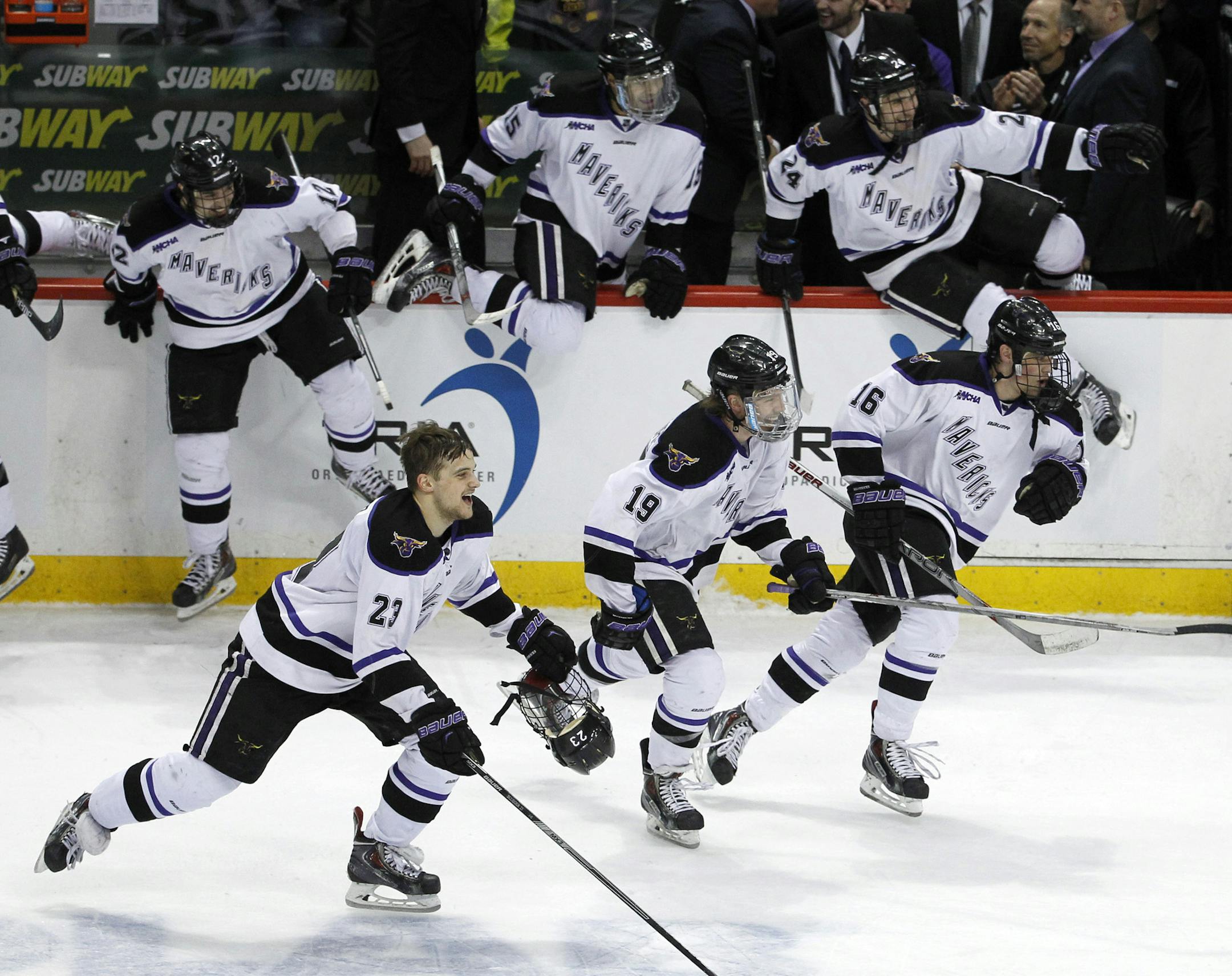 Minnesota State Mankato forwards Teddy Blueger (23), Brad McClure (19), and Jordan Nelson (16) join teammates in celebration after defeating Michigan Tech 5-2 to win the WCHA Final Five college championship hockey game in St. Paul, Minn., Saturday, March 21, 2015. (AP Photo/Ann Heisenfelt)