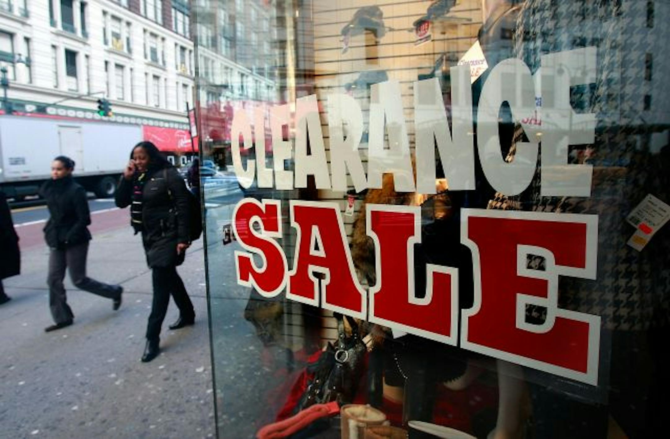 NEW YORK - JANUARY 08: People walk past a "Clearance Sale" sign at a clothing store January 8, 2009 in New York City. New retail sales numbers compiled by the International Council of Shopping Centers indicate sales fell 2.2 percent for the holiday shopping season, the largest downswing since at least 1970.