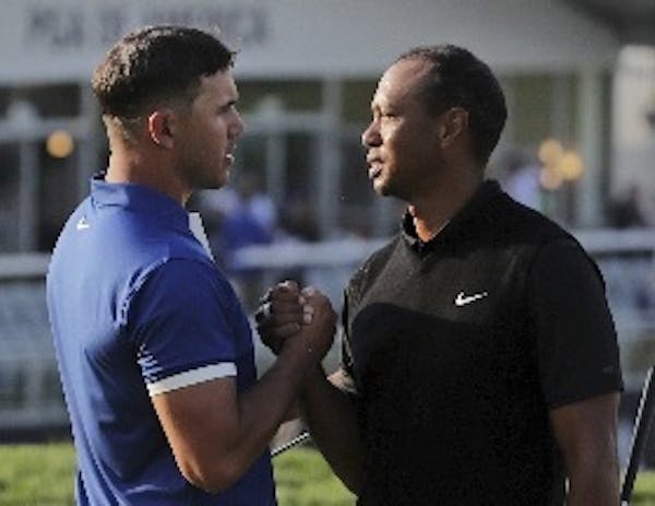 Brooks Koepka, left, and Tiger Woods played in the same group for the first two rounds of the PGA Championship at Bethpage Black in Farmingdale, N.Y. 