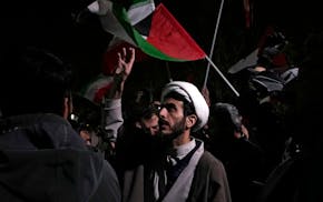 A cleric chants slogans during an anti-Israeli gathering in front of the British Embassy in Tehran, Iran, early Sunday, April 14, 2024.