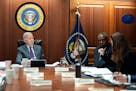 In a photo provided by the White House, President Joe Biden receives the presidential daily briefing on Monday as Defense Secretary Lloyd Austin liste