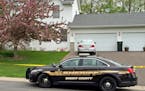 An off-duty Elk River police officer and another man were shot and killed in a home in St. Michael, and one of the officer&#xed;s sons was arrested, o