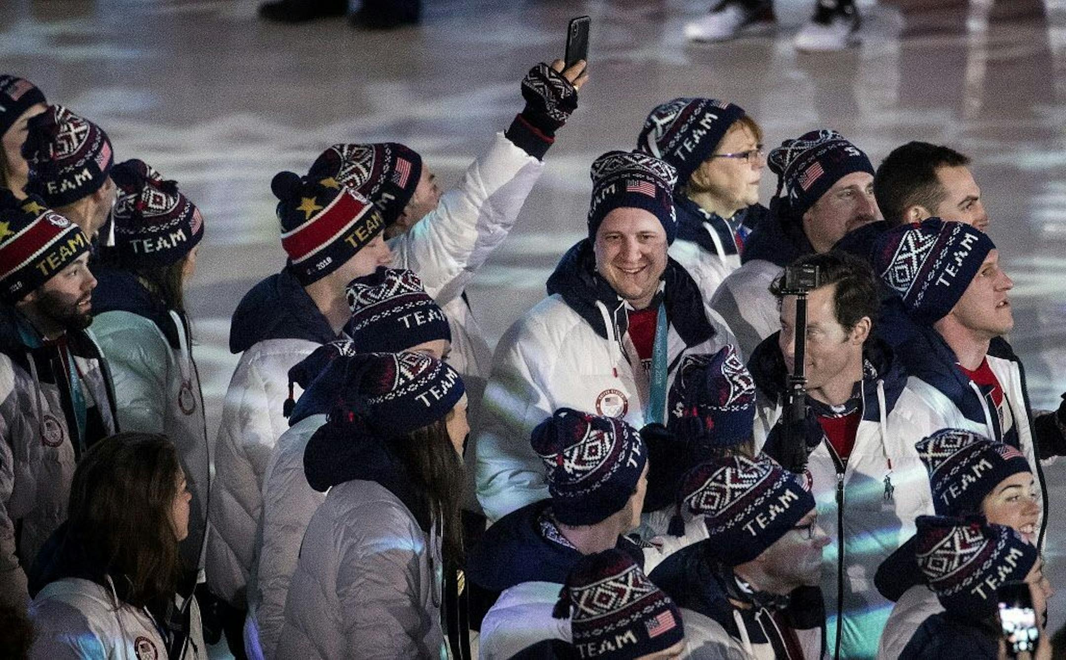 John Shuster (middle) and team USA entered Pyeongchang Olympic Stadium during Closing Ceremony on Sunday.