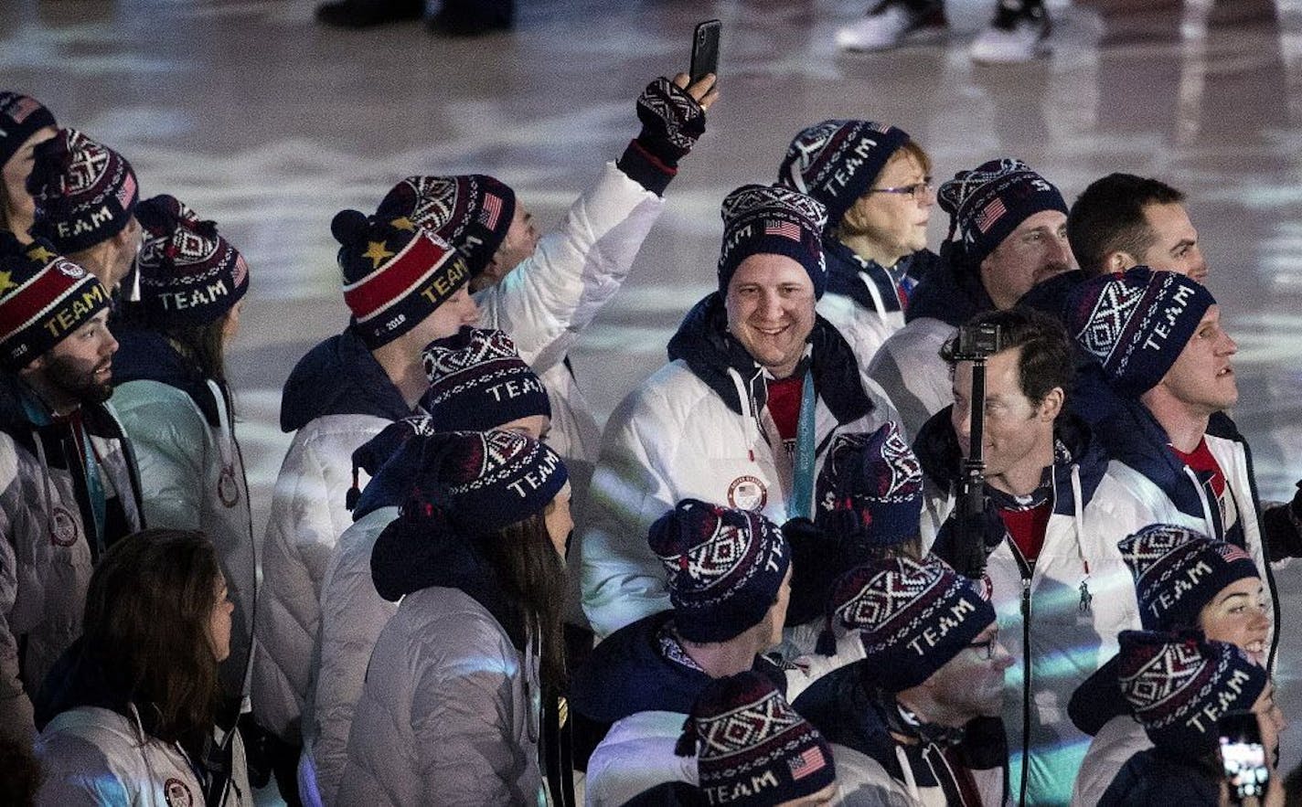 John Shuster (middle) and team USA entered Pyeongchang Olympic Stadium during Closing Ceremony on Sunday.