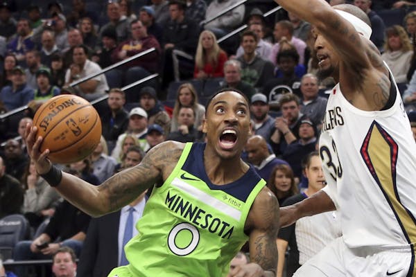 Minnesota Timberwolves' Jeff Teague, left, drives around New Orleans Pelicans' Dante Cunningham in the first half of an NBA basketball game Saturday, 