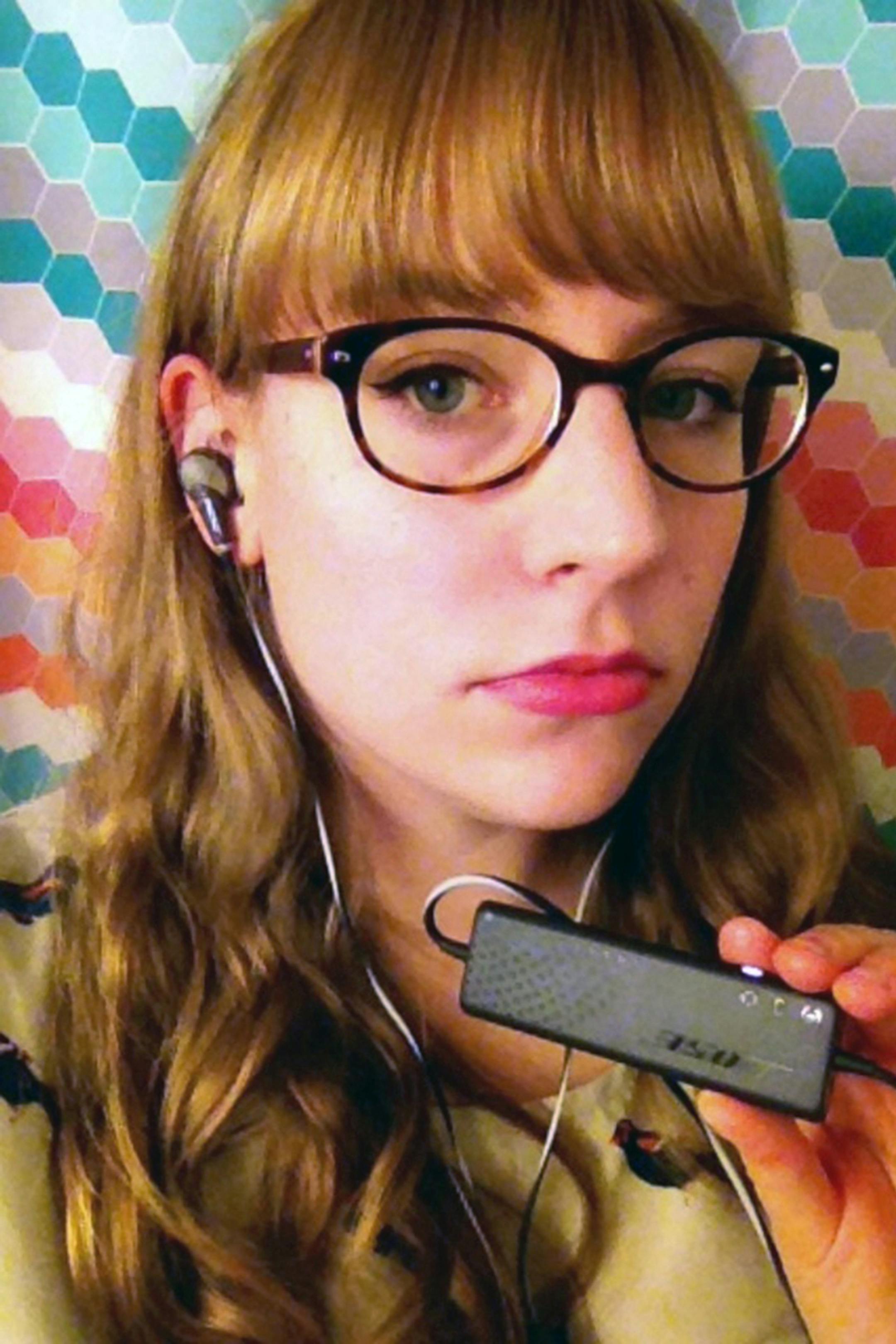 Meredith Rosol wears her Bose Quiet Comfort noise-canceling earbuds. She often uses these during family meals to block out the noise of others eating. Illustrates HEALTH-NOISE (category l), by Meeri N. Kim, special to The Washington Post. Moved Tuesday, December 02, 2014. (MUST CREDIT: Courtesy of Meredith Rosol.)