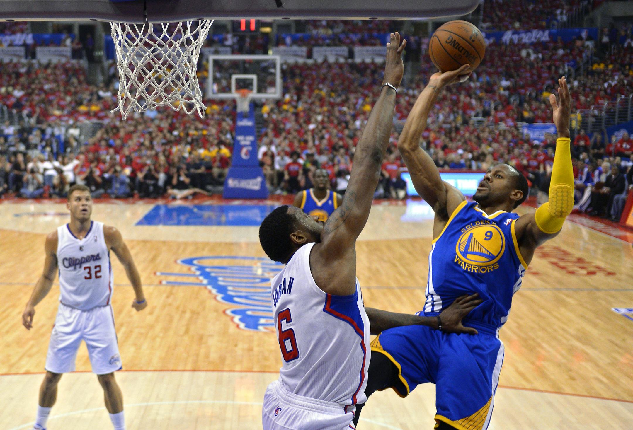 Golden State Warriors forward Andre Iguodala, right, puts up a shot as Los Angeles Clippers center DeAndre Jordan, center, defends and forward Blake Griffin looks on during the first half in Game 7 of an opening-round NBA basketball playoff series, Saturday, May 3, 2014, in Los Angeles. (AP Photo/Mark J. Terrill)