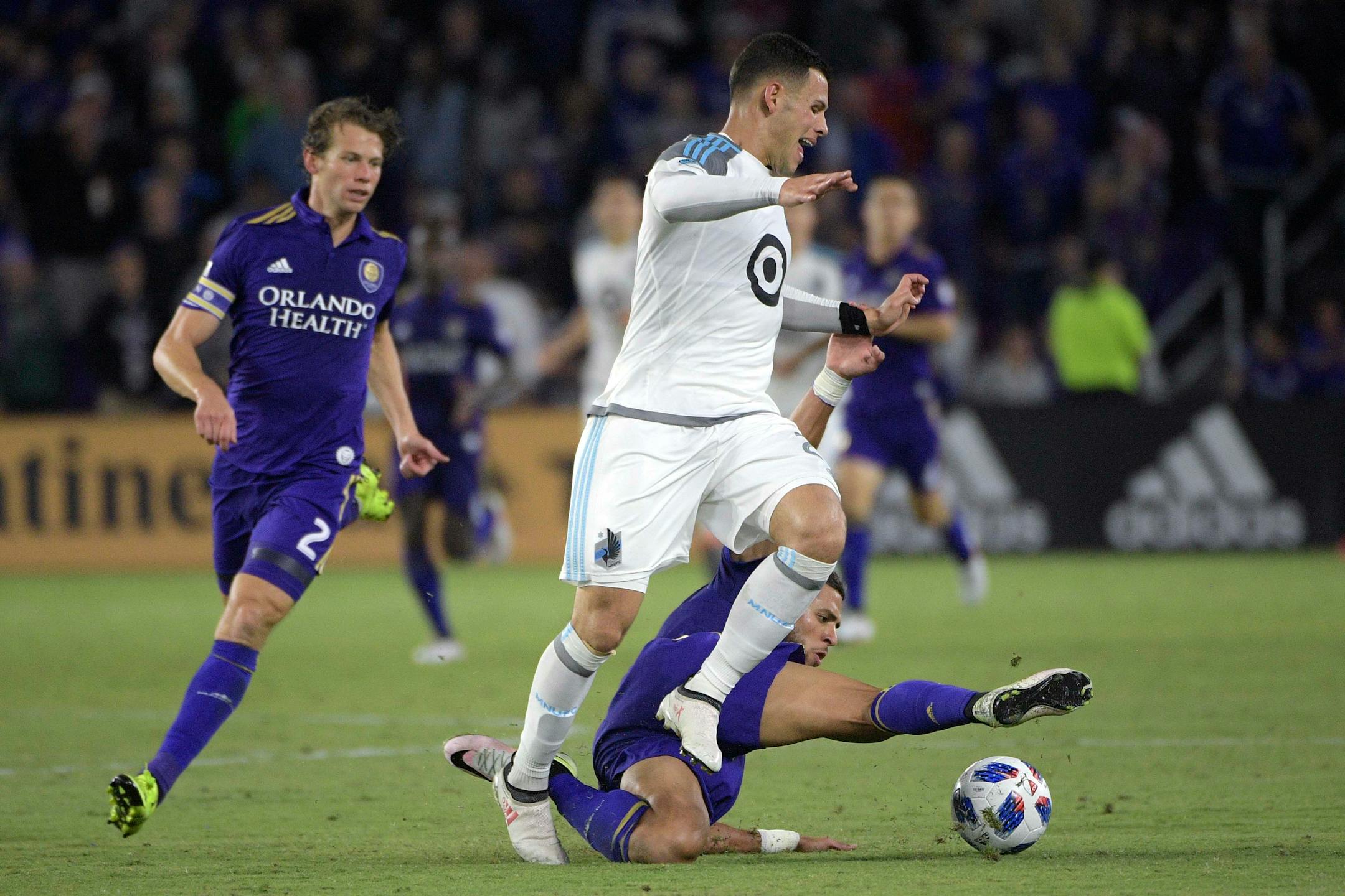 Minnesota United forward Christian Ramirez and Orlando City defender Amro Tarek, right, battle for the ball during the first half of an MLS soccer match Saturday, March 10, 2018, in Orlando, Fla. Minnesota won 2-1. (Phelan M. Ebenhack for the Star-Tribune) ORG XMIT: OTKMINN125