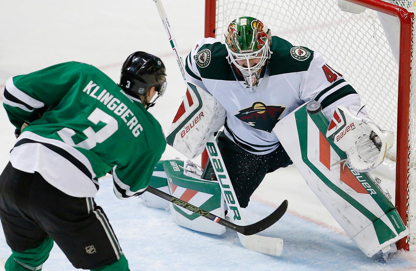 Dallas Stars defenseman John Klingberg (3) shoots the puck past Minnesota Wild goalie Devan Dubnyk (40) to score the game-winning goal in overtime during an NHL hockey game, Saturday, Nov. 14, 2015, in Dallas. Dallas won 3-2. (AP Photo/Brandon Wade)