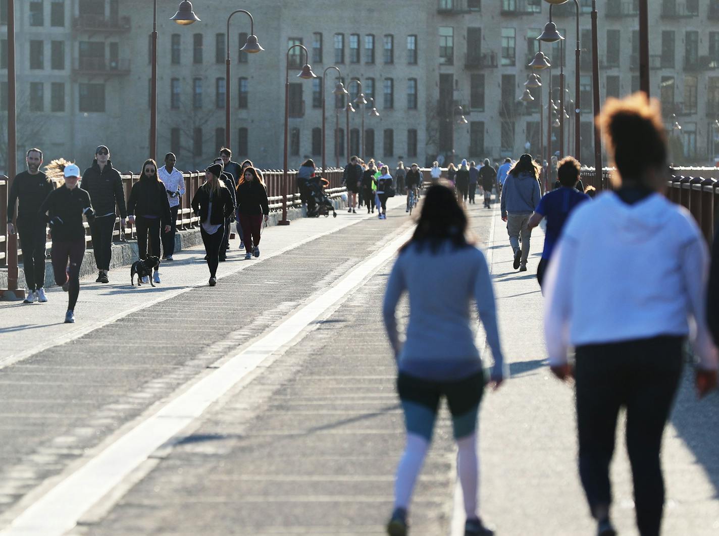 With sunny spring weather becoming the norm, people are getting out and embracing the warmer temps while not all practicing social distancing as evidenced the Stone Arch Bridge during the COVID-19 outbreak Tuesday, March 31, 2020, in Minneapolis, MN.] DAVID JOLES &#x2022; david.joles@startribune.com COVID photos of the day