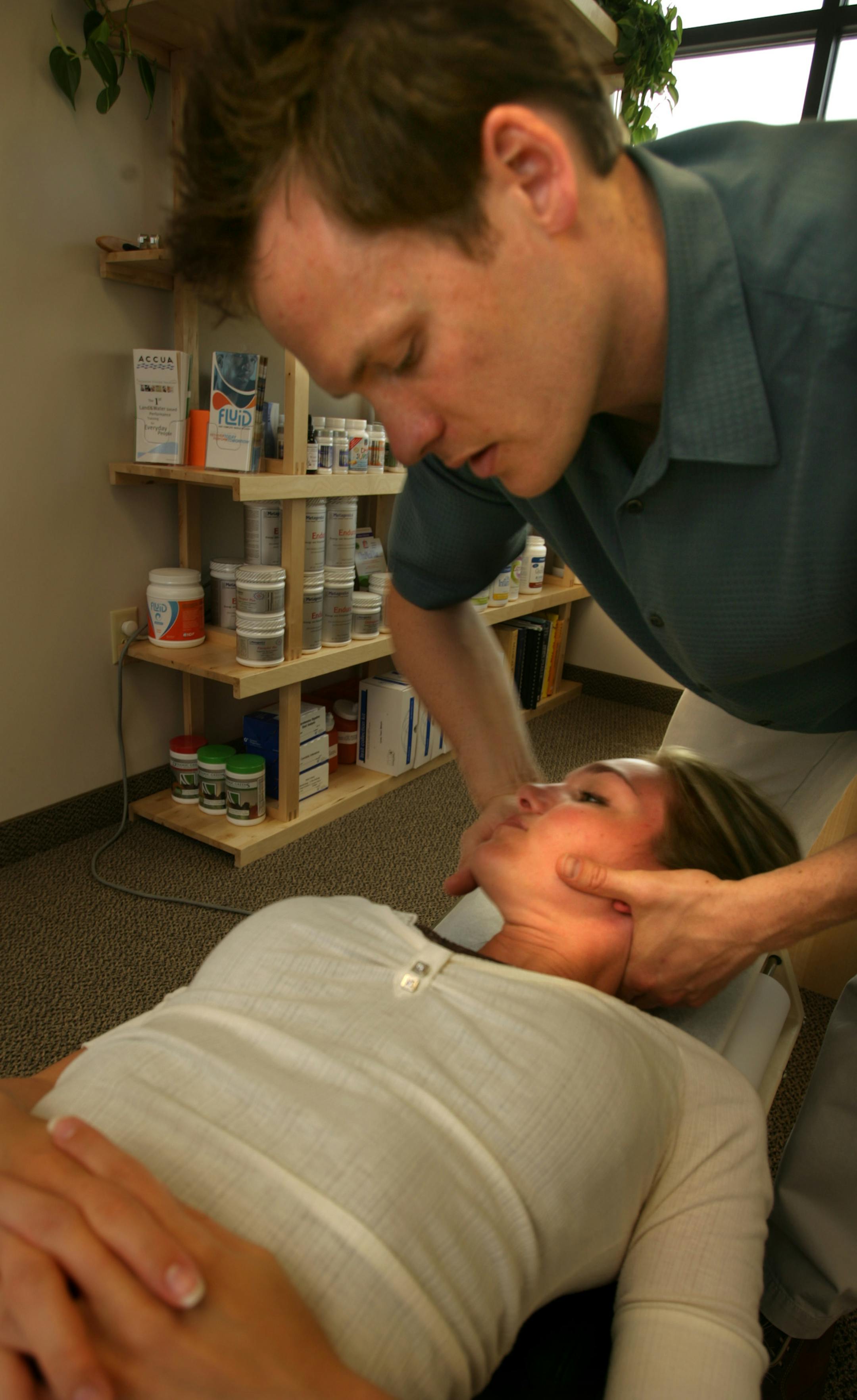 Dr. Chris Frykman worked on Annette Neist's neck at his office in Shakopee, using applied kinesiology.