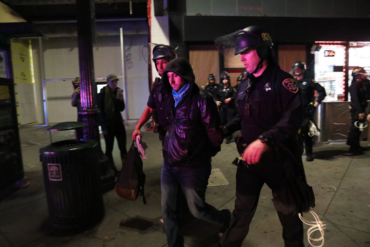 Police detain a protester, one of many gathered in the streets denouncing Donald TrumpÕs victory in the presidential race, in Oakland Calif., in the early morning hours of Nov. 9, 2016.