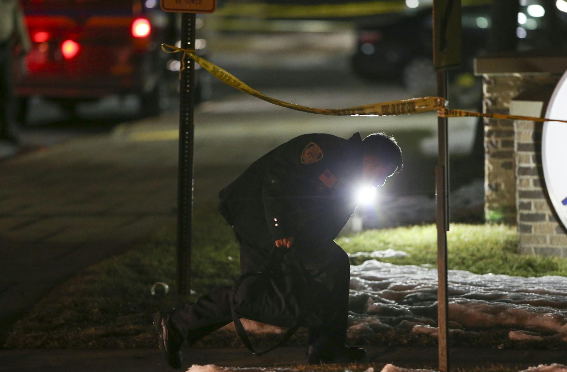 The scene outside the New Hope Police Department on Xylon Ave. N. late Monday night. A New Hope Police Reservist ducked under the crime scene tape outside the police department on his way into the building. ] JEFF WHEELER &#x201a;&#xc4;&#xa2; jeff.wheeler@startribune.com Shortly after a swearing-in ceremony at New Hope City Hall, two New Hope police officers were shot and wounded by a man with a rifle Monday night, January 26, 2015. Both officers are expected to survive their injuries.