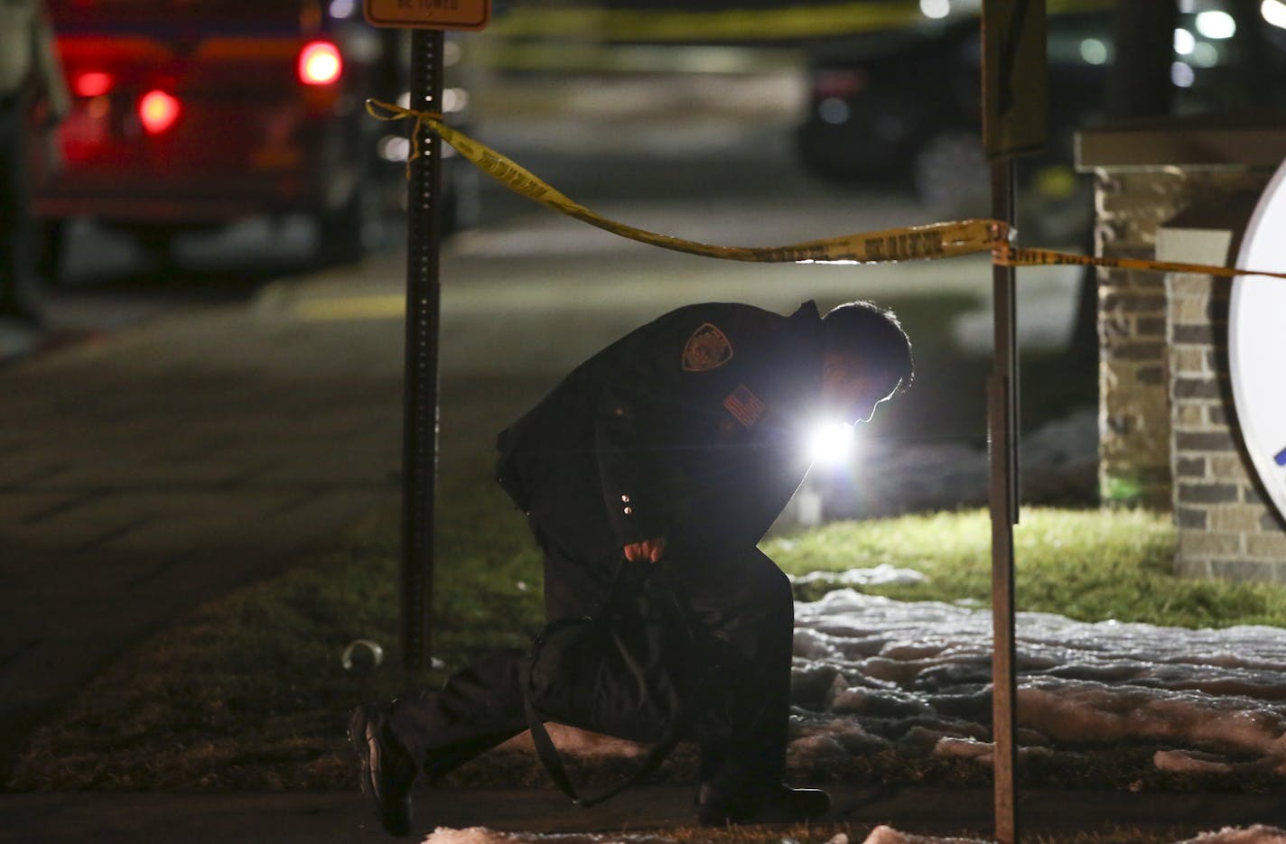 The scene outside the New Hope Police Department on Xylon Ave. N. late Monday night. A New Hope Police Reservist ducked under the crime scene tape outside the police department on his way into the building. ] JEFF WHEELER &#x201a;&#xc4;&#xa2; jeff.wheeler@startribune.com Shortly after a swearing-in ceremony at New Hope City Hall, two New Hope police officers were shot and wounded by a man with a rifle Monday night, January 26, 2015. Both officers are expected to survive their injuries.