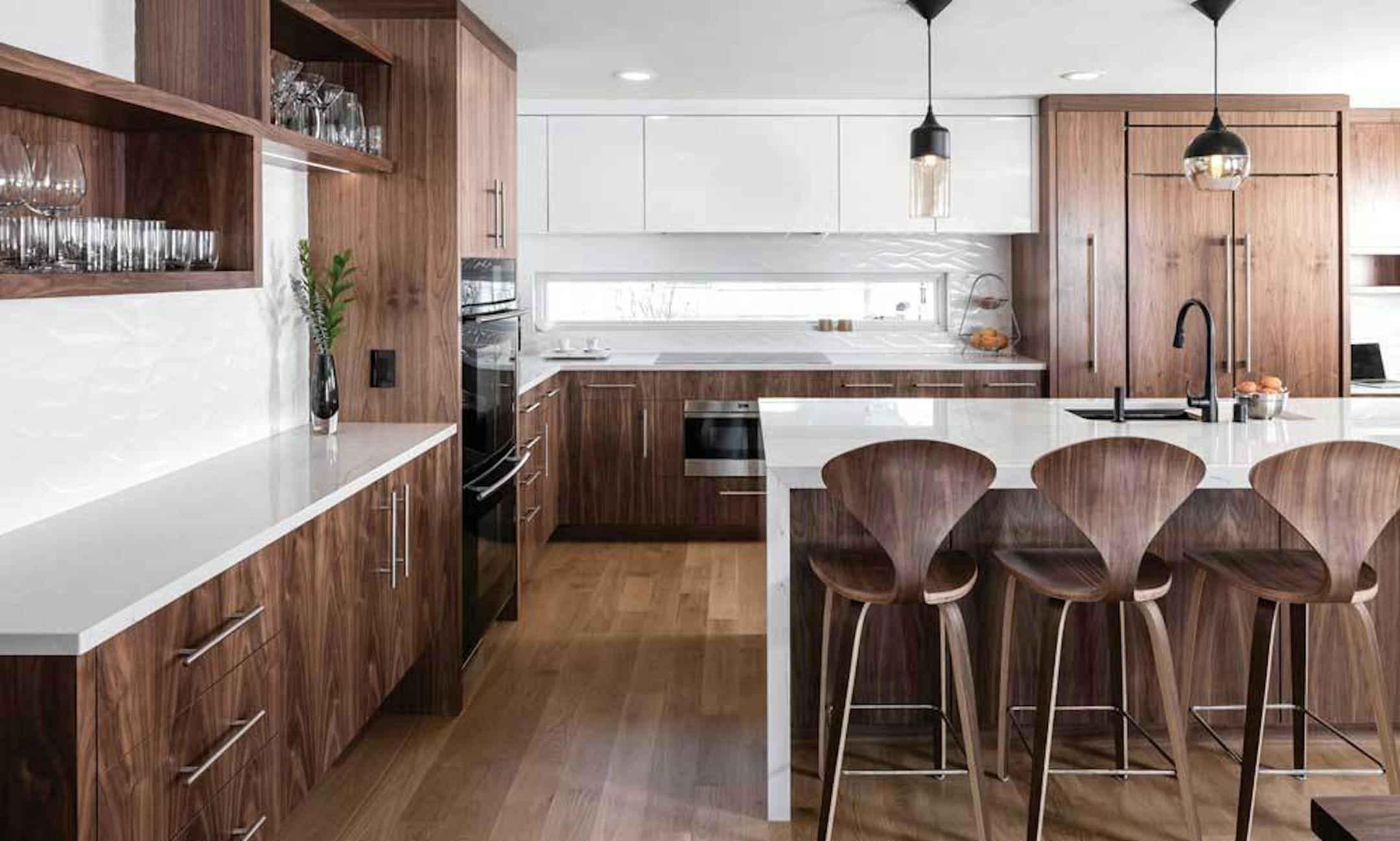 This kitchen designed by Shelter Architecture featuring dark wood and black appliances is on the ASID Designer Kitchen Tour. Provided