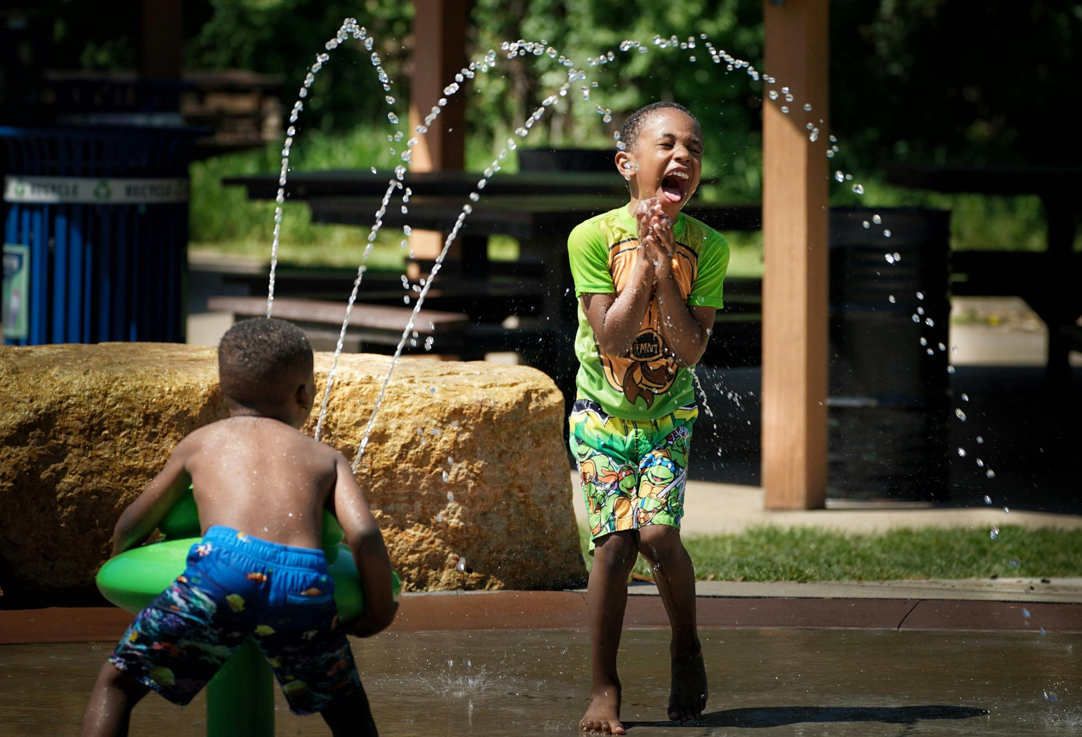 Levi Brown, 5, squirted his new friend Elijah Coleman, 5, at Cliff Fen Park in Burnsville. ] GLEN STUBBE * gstubbe@startribune.com With Temperatures heading into the 90's this weekend, the Twin Cities has lots of places to cool off including here at Cliff Fen Park in Burnsville. Friday, May 25, 2018
